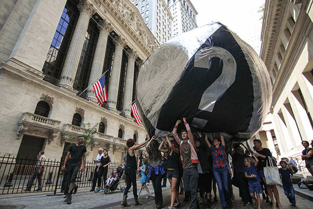 Activists carry a 16-foot inflatable carbon bubble in front of the Stock Exchange in New York City, New York. All photos by Artur van Balen.