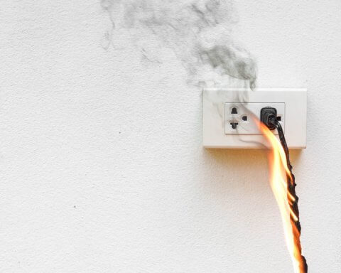 Canada: Switch from fossil fuels to clean electricity | An image of an electrical outlet on fire